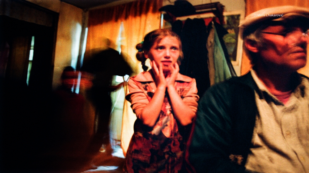 A girl worries about the fate of her sister, who left for Turkey three years prior to this photo being taken. The family had only heard from her once – a letter she sent to her home village. Her parents didn't know whether she was still alive. I travelled to Turkey and was able to find her. She had been trafficked for sex in Istanbul, but a client helped her escape. He married her, and they have a child together. She called her parents the day I found her to tell them she is alive but can't return home because the pimps kept her passport. She remains in Turkey as an illegal immigrant, and rarely leaves the house out of fear of being deported and losing custody of her son - Moldova, 2004 [Mimi Chakarova]