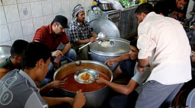 Displaced people wait for free food in a mosque [AP]