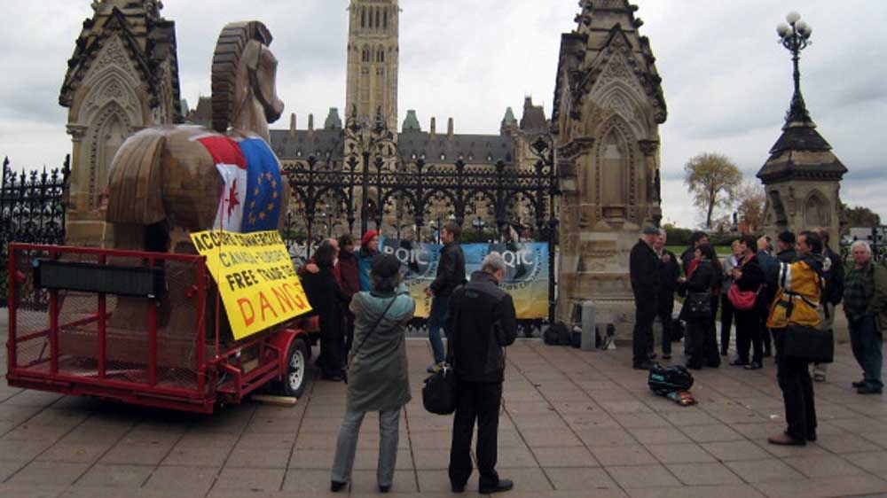 Activists gather in front of the Canadian parliament to protest against closed door negotiations between Canada and the European Union on a free trade deal [AFP]