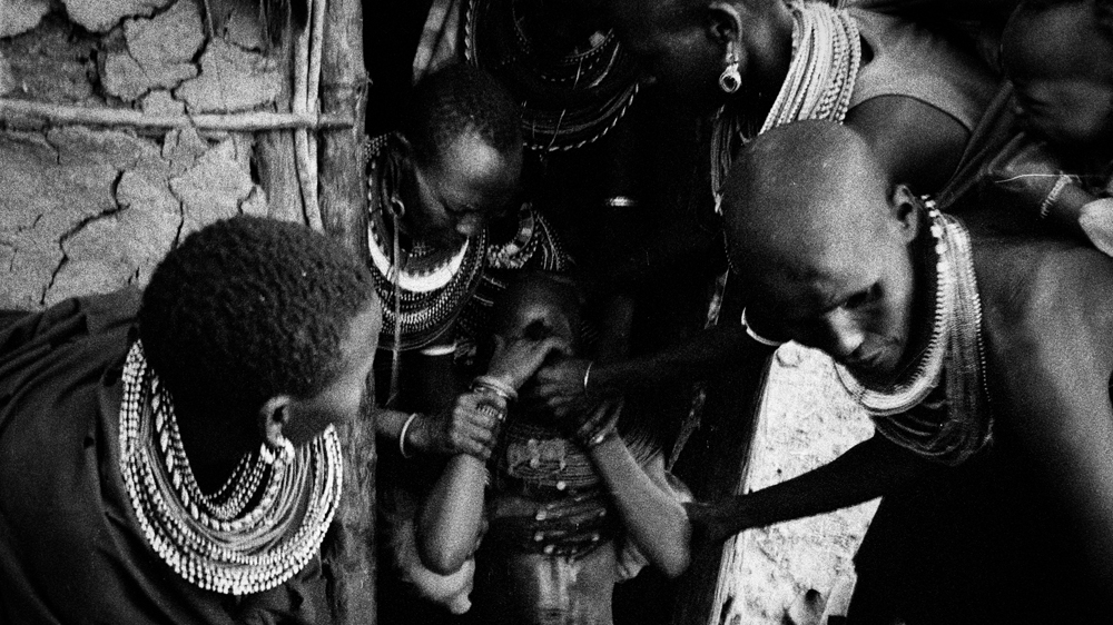 Women hold Juliana down during the excision. The labia major, labia minora and clitoris are all completely removed. In the case of some remaining, the 'circumciser' will return later to complete the job. During the ritual, Juliana is not meant to utter a word, as to do so is considered to bring shame upon her family [Mariella Furrer]