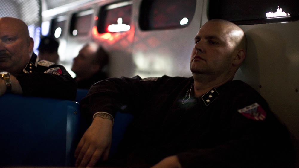 Jeff Hall and other members of the National Socialist Movement are transported by prison buses to a rally in New Jersey. The state police requested that NSM members park their cars at the state police barracks and be transported via the buses in order to minimise the likelihood of clashes with counter-protesters [Julie Platner]
