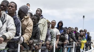 Migrants wait to disembark on the Italian island of Lampedusa [AP]