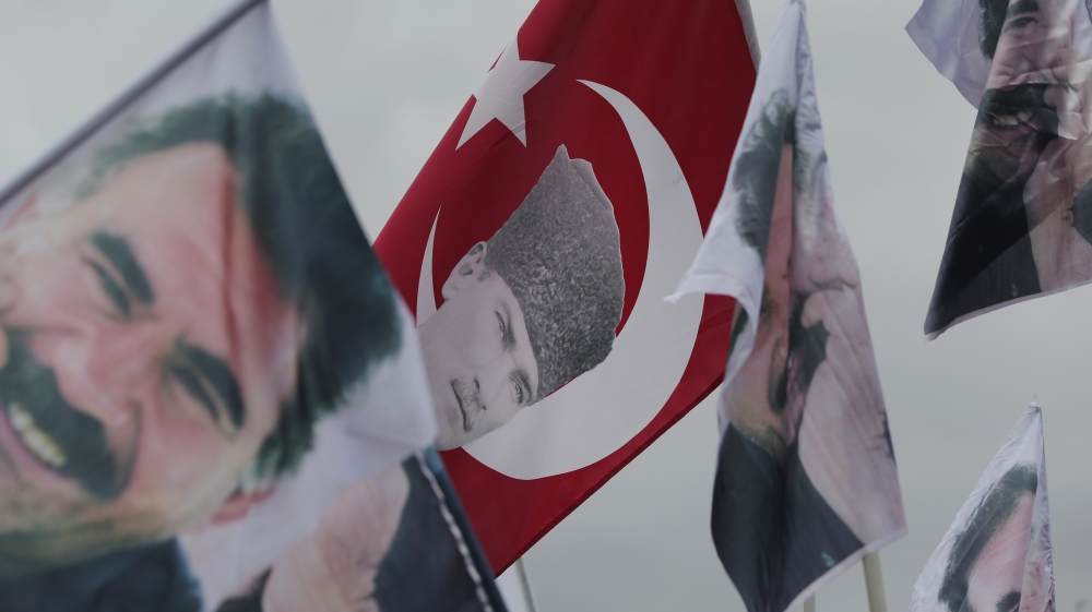 HDP supporters wave a flag with Turkish Republic founder Mustafa Kemal Ataturk, and others of imprisoned Kurdish rebel leader Abdullah Ocalan, during a rally in Istanbul [AP]