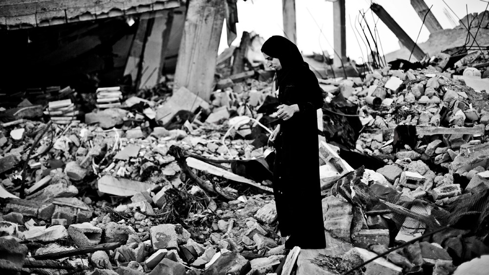 Sabrina walks through the ruins of her house. During the bombing, she hid in a shelter with her aunt. When she left the shelter during the first ceasefire, she discovered the lifeless body of her brother [Virginie Nguyen Hoang/Hanslucas/Collectif Huma] 