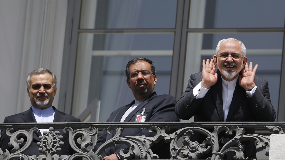Iranian Foreign Minister Mohammad Javad Zarif reacts as he stands at a balcony of the Palais Coburg hotel where the Iran nuclear talks are being held in Vienna