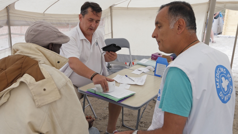 A migrant receives a medical consultation at a field dispensary set up by the French doctors group Medecins du Monde at a makeshift tent city located in a field in Calais