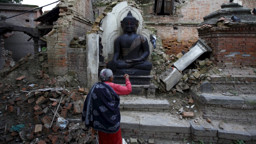 A woman offers daily prayers at the statue of Lord Buddha