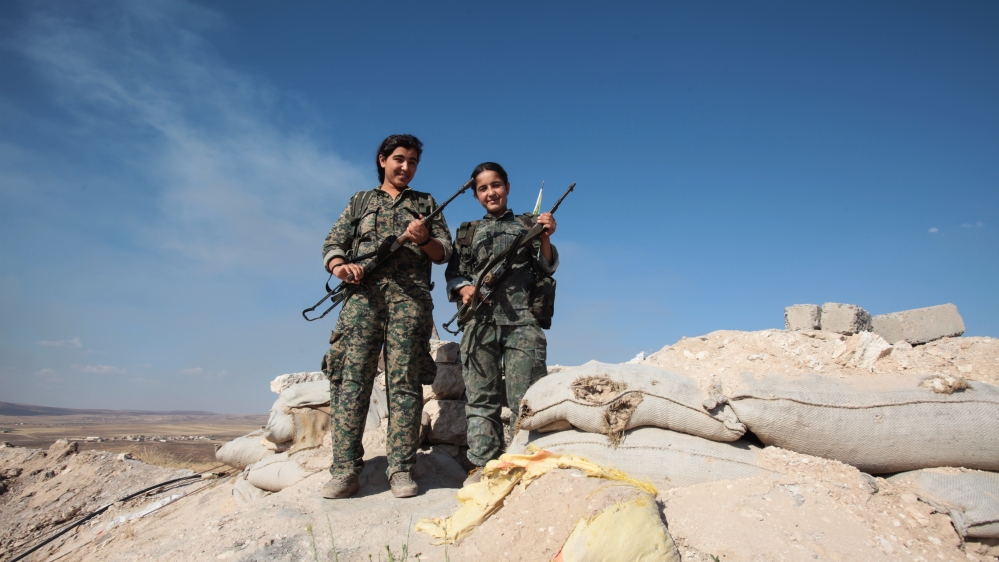 YPG''s women fighters pose as they stand in a check point with their AK-47 at the outskirts of the destroyed Syrian town of Kobane [Getty]