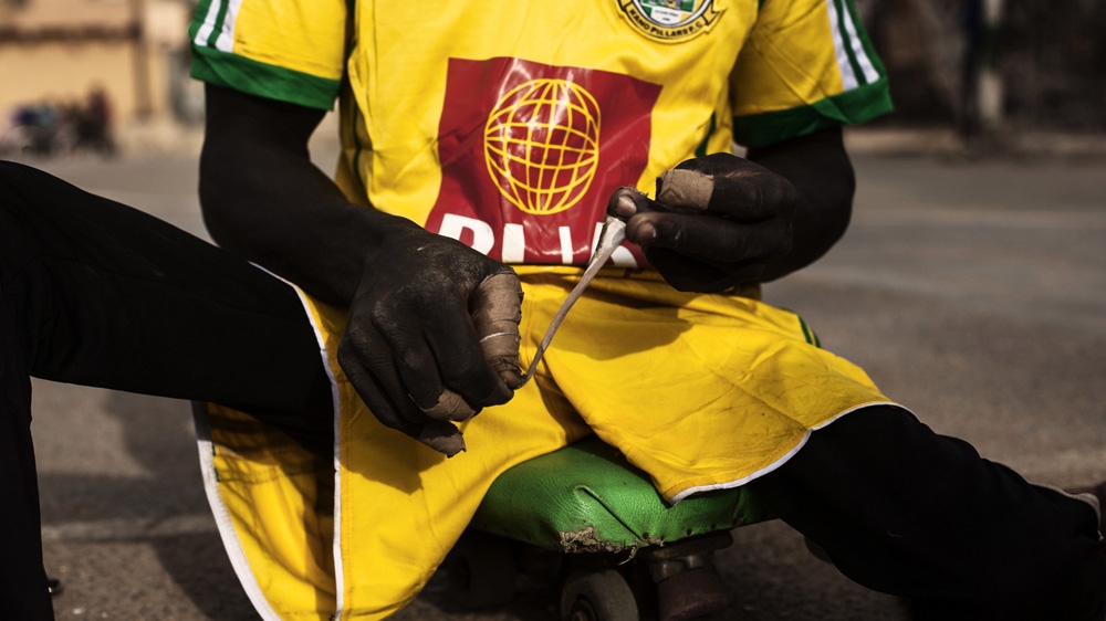 A player wraps tape around his hands. It helps to protect them against the hard ground as they use their hands to manoeuvre their skateboards [Diego Ibarra Sanchez/MeMo]