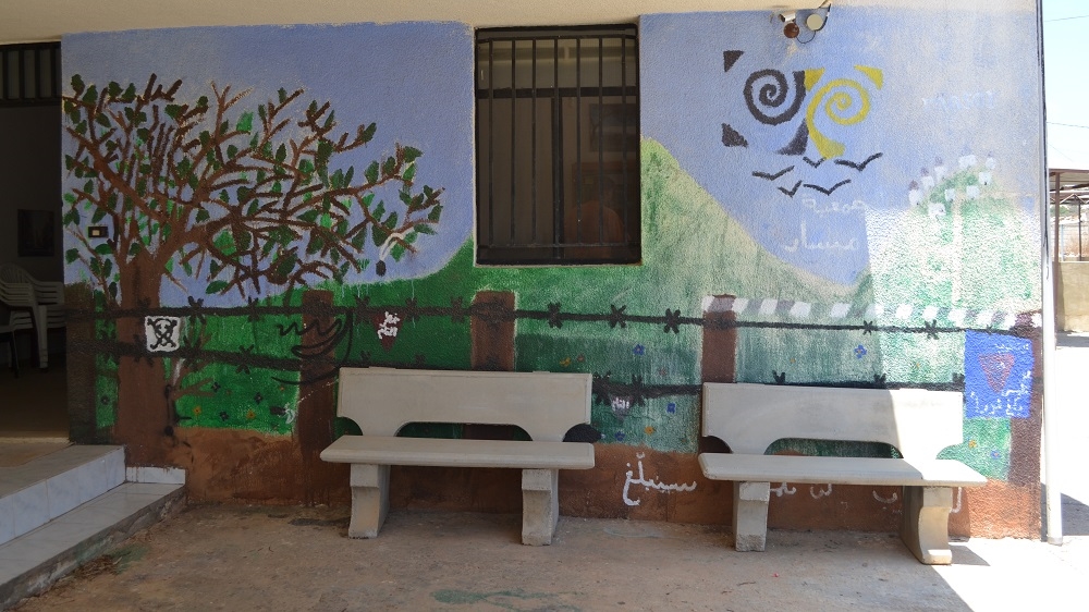 Murals warn of the dangers of unexploded ordnance in schools and public buildings across southern Lebanon [Joseph Ataman/Al Jazeera]