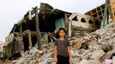 11-year-old Yihab al-Tayeb stood motionless in front of his house [Charlene Ann/Al Jazeera]
