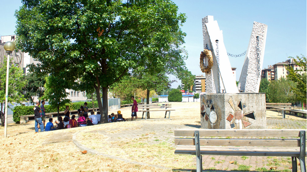 An anti-Mafia seminar taking place by a monument commemorating assassinated judge Giovanni Falcone in Trezzano [Antonella Corigliano/Al Jazeera]