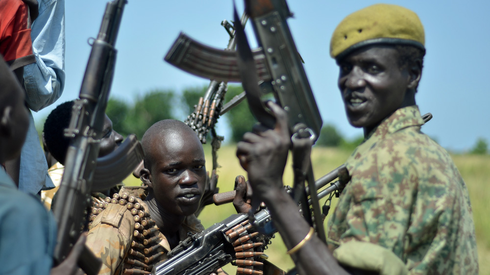 Soldiers who form the government commissioner's guard show off their weapons in Koch town [Jason Patinkin/Al Jazeera] 