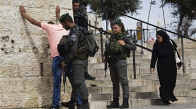 Israeli border policemen perform a security check on a Palestinian youth at Damascus Gate just outside Jerusalem's Old City [Reuters]