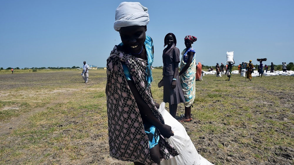 The World Food Programme provided aid recipients with half-full bags of food in case they have to flee from attacks [Jason Patinkin/Al Jazeera]