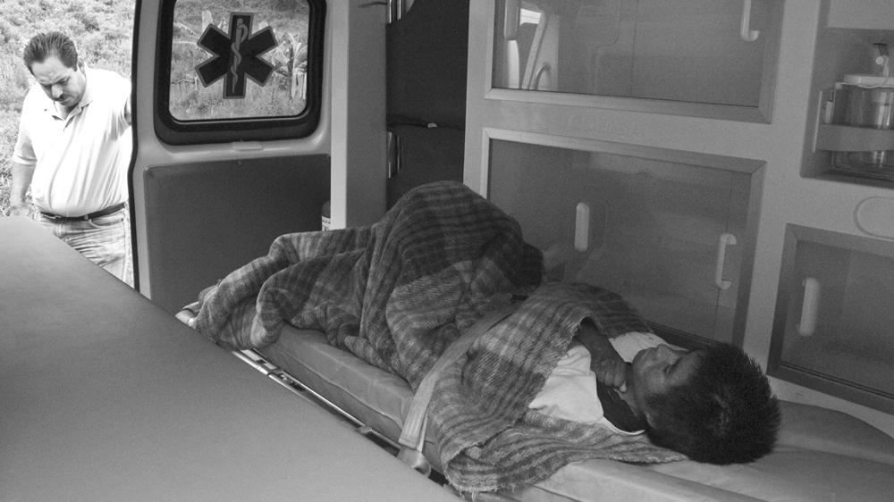 Maurilia is placed on a stretcher in the ambulance [Prometeo Lucero]