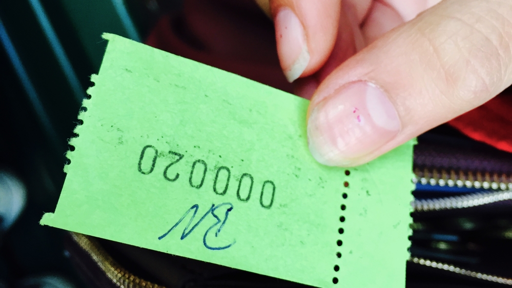 Refugees are given call numbers and wait outside in the cold for hours for their turn to register [Ash Gallagher/Al Jazeera]