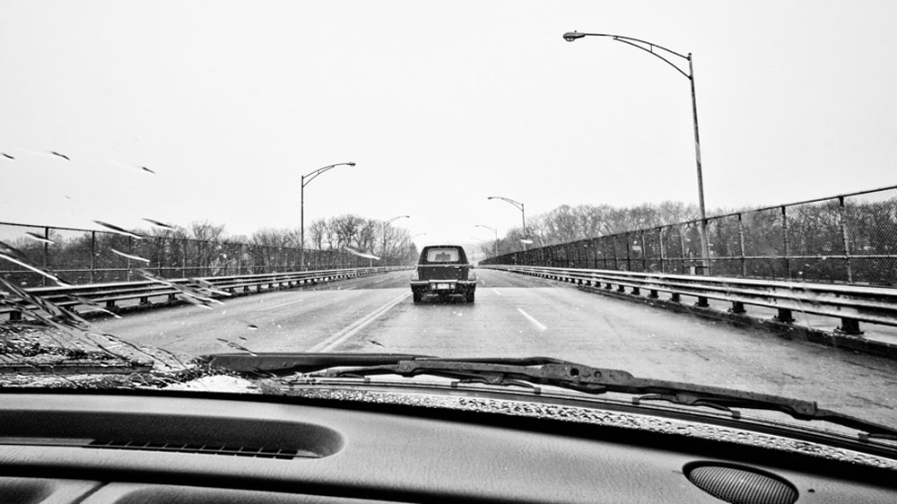 A light snow falls as we follow the hearse transporting Jen's casket to the cemetery. [Angelo Merendino/Al Jazeera]