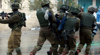 Israeli soldiers detain a Palestinian protester during clashes in the West Bank city of Bethlehem [Reuters]