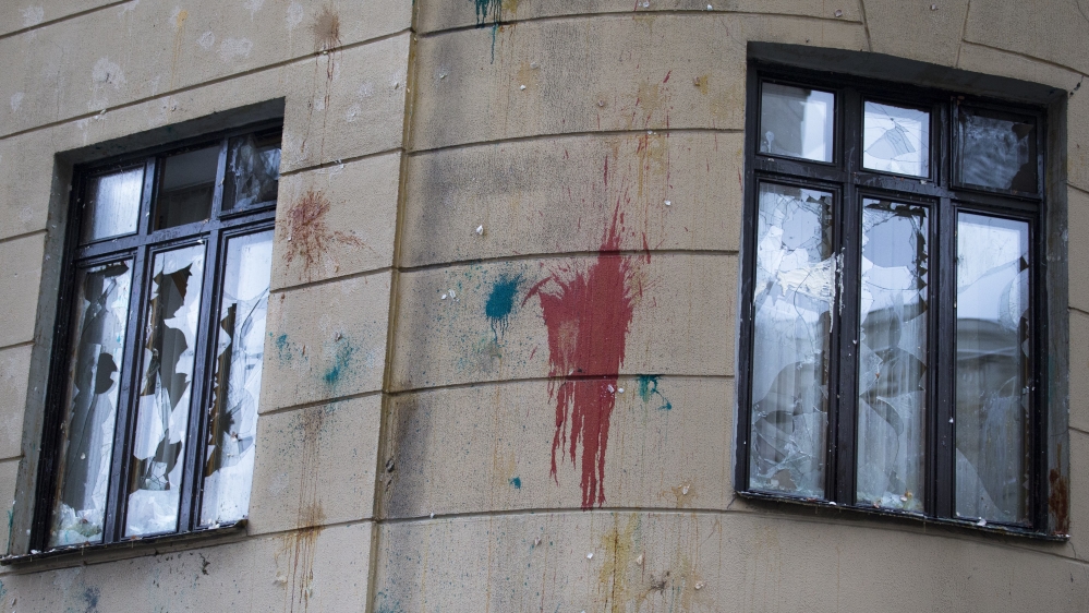 Windows are shattered and walls have traces of pelted eggs after a protest at the Turkish E