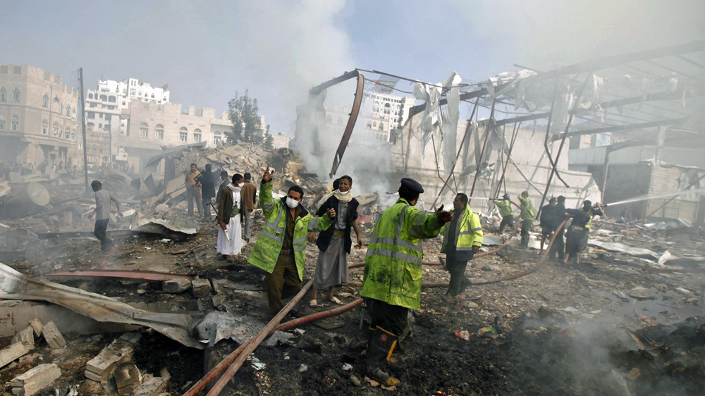 Firefighters react as they put out a fire at a food storage warehouse hit by a Saudi-led air strike in Yemen''s capital Sanaa