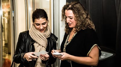 Green Caravan cofounder Reham Alsamerai, pictured at right, collects votes for the audience award [Reham Alsamerai/Al Jazeera]