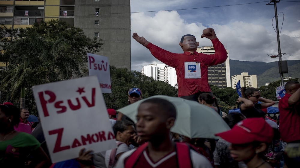 A group of government supporters gather in front of a Chavez doll during the closing rally [Alejandro Cegarra/Al Jazeera]