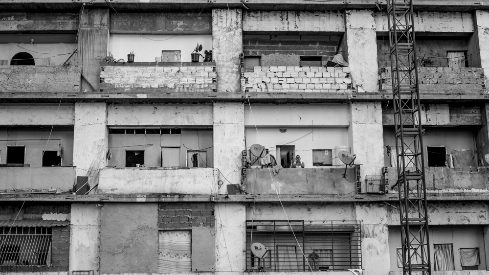 A man takes a photograph from the west facade of the Tower of David [Alejandro Cegarra/Al Jazeera]