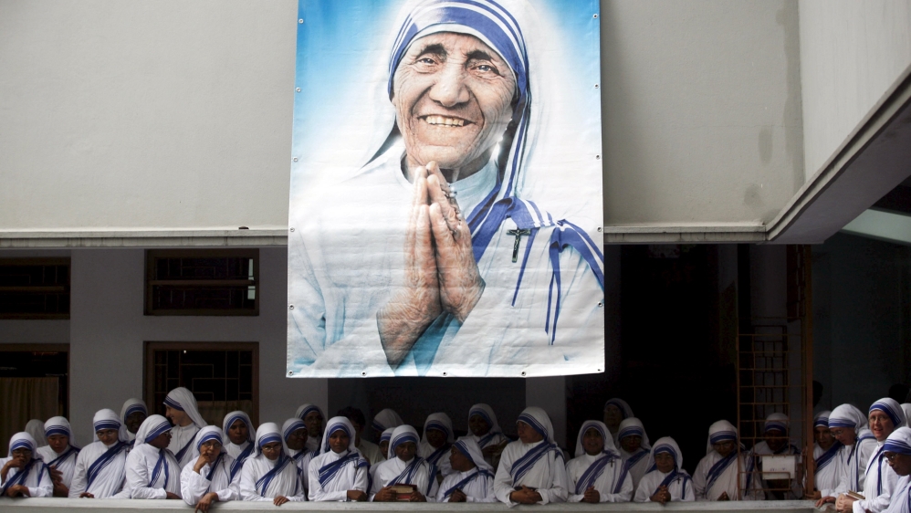 File photo of Catholic nuns from the order of the Missionaries of Charity gather under a picture of Mother Teresa in Kolkata
