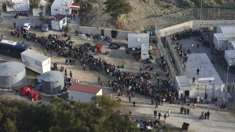 Refugees and migrants wait to be registered at a site on the Greek island of Lesbos [Greek Prime Minister's Office/Reuters] 