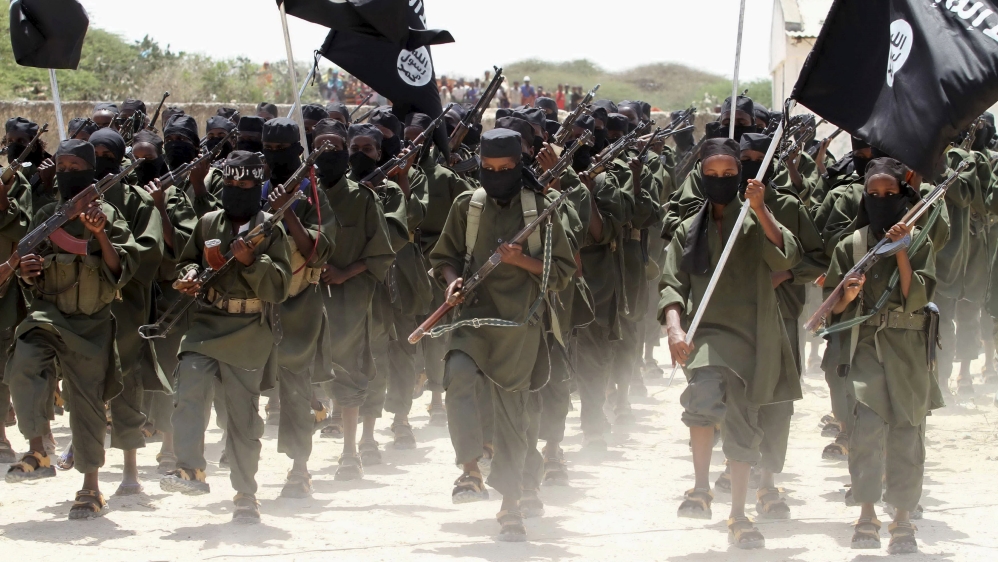 File photo of new recruits belonging to the al Shabaab militant group marching during a passing out parade at a military training base in Afgoye