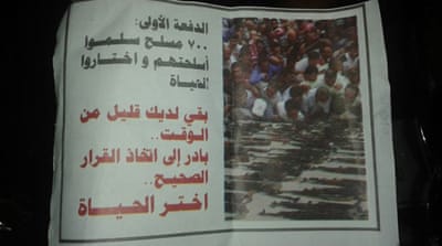 'The first group: 700 armed men surrendered their weapons and chose life. Only a little time is left for you. Hurry to make the right choice: Choose life' [Salim al-Shami/Al Jazeera]