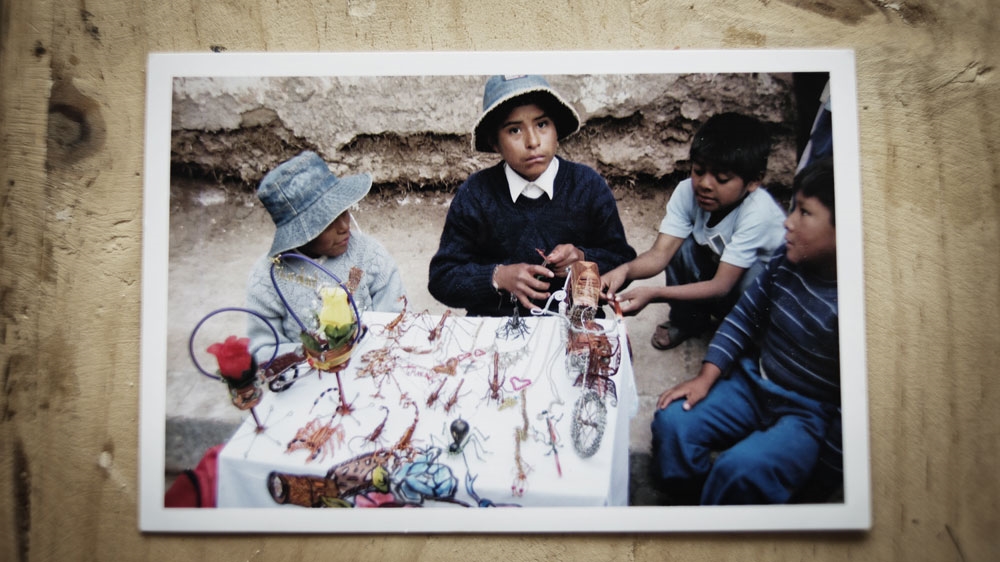 A childhood photograph of Quipse selling some his first creations made from copper wires [Valentino Bellini/Al Jazeera]