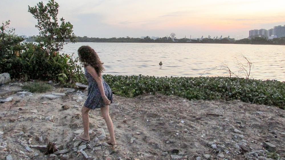 Perola Luz, who wants to be a photographer when she is older, shows the site of recent demolitions. When asked about what the area used to look like, she says she tries not to think about that [Maya Thomas-Davis/Al Jazeera]