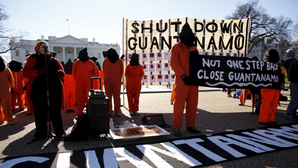 Protesters in orange jumpsuits from Amnesty International USA and other organizations rally outside the White House to demand the closure of the U.S. prison at Guantanamo Bay, in Washington