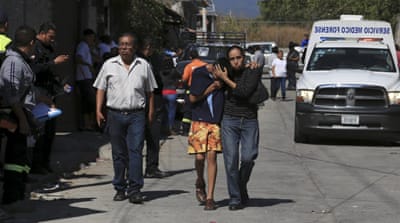 Mourners gather near Mota's home after the killing [Margarito Perez/Reuters]