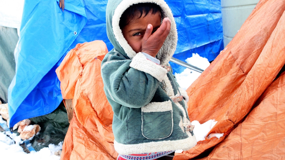 Syrian refugees in snow at the Barelias refugee camp