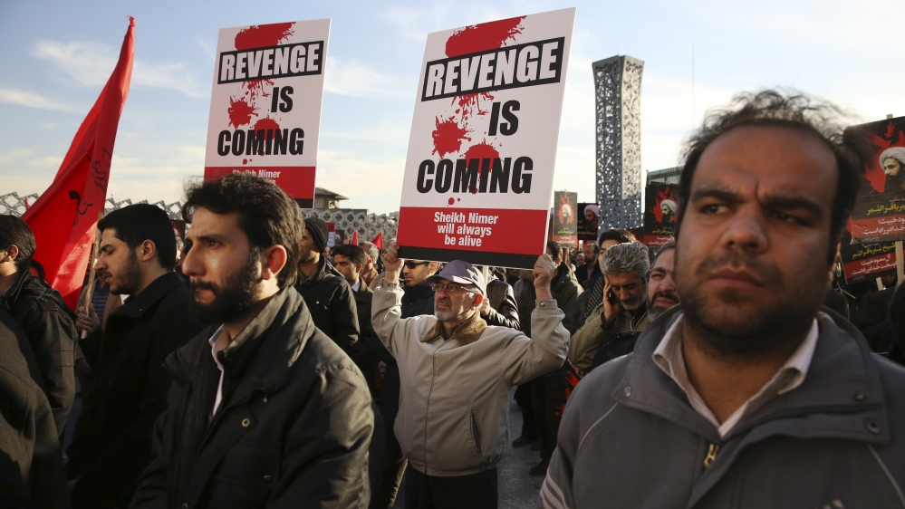 Iranian demonstrators hold anti-Saudi placards in a rally to protest the execution by Saudi Arabia of Sheikh Nimr al-Nimr [AP]