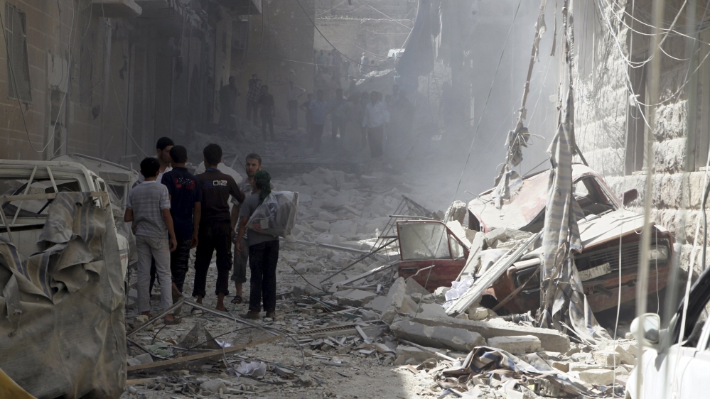 Residents inspect damage from what activists said was an airstrike by forces loyal to Syria''s President Bashar al-Assad in al-Ansari neighborhood of Aleppo, Syria