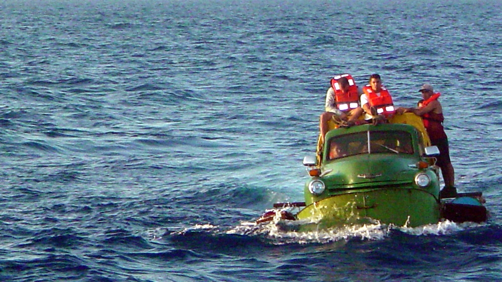 Cuban migrants trying to reach the US coast of Florida ride in a makeshift boat made out of a 1951 Chevrolet truck [Fireman Gregory Wald/US Coast Guard/Getty Images]