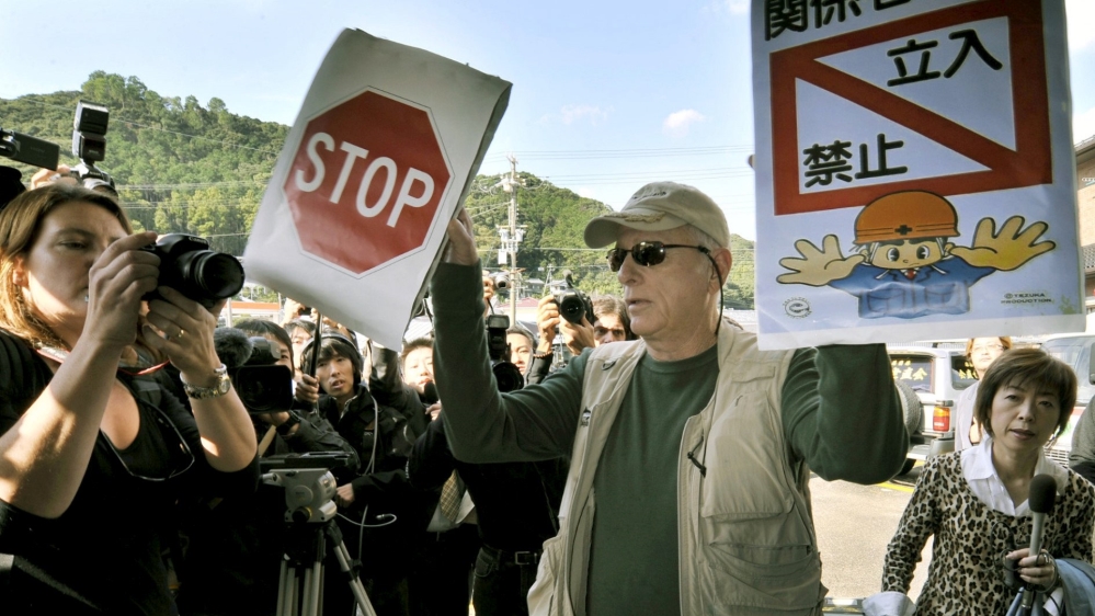 Ric O''Barry, a U.S. dolphin conservationist who appeared in the Oscar-winning documentary "The Cove", holds signs to protest against dolphin hunting in Taiji town