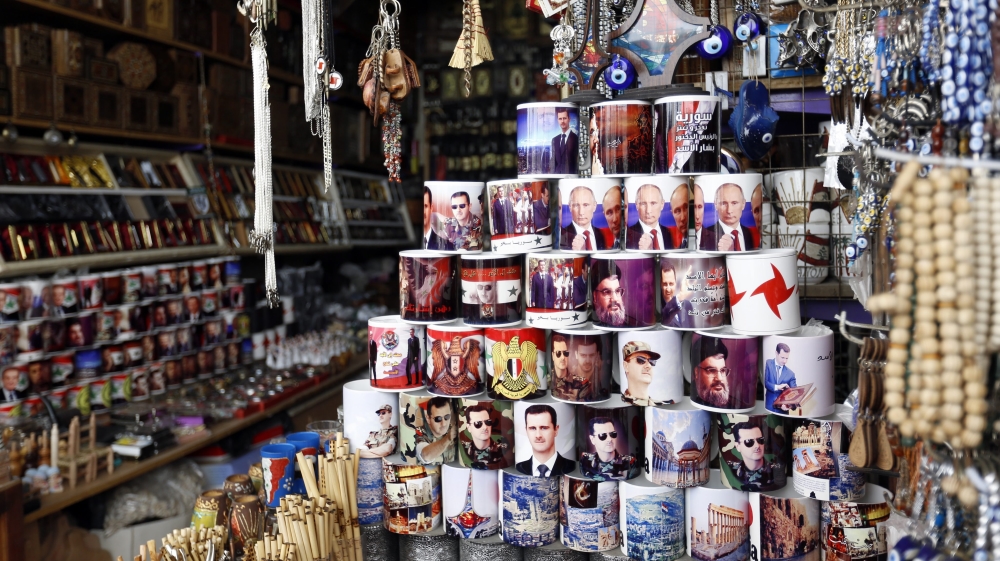 Local Syrian shop sell mugs with photos of Bashar al-Assad, Vladmir Putin, Hezbollah leader Hassan Nassrallah, and the national Syrian flag in the old city of Damascus, Syria [EPA]