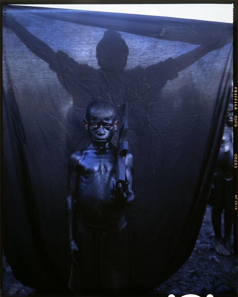 A Sing-Sing performer carrying a wooden gun to represent an Australian colonial patrol officer at the Mount Hagen Show in the Western Highlands. 2011 [Stephen Dupont/Al Jazeera] 