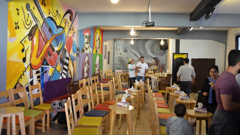 The cafe can seat up to 60 people and includes a professional sound system and a small stage [India Stoughton/Al Jazeera]