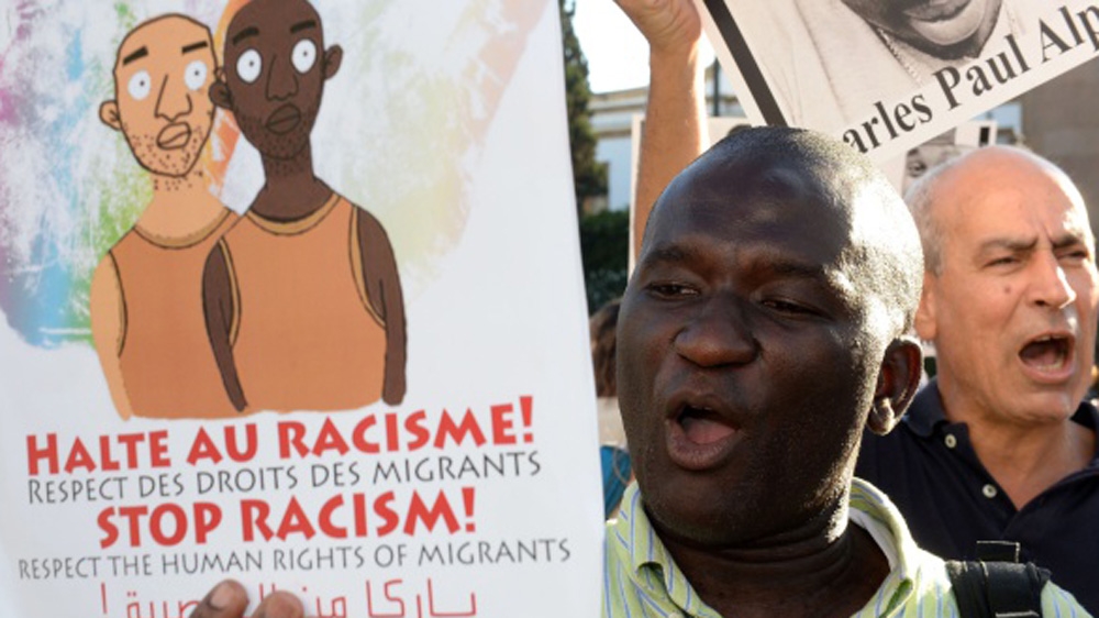 Protesters shout slogans as they hold placards during a demonstration in Rabat against racism in Morocco in 2014 [AFP]