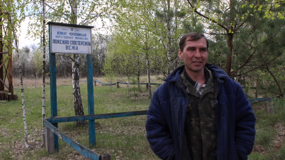 Serhiy Kostovsky works in a Soviet-era fire tower in the exclusion zone [Christian Borys/Al Jazeera]