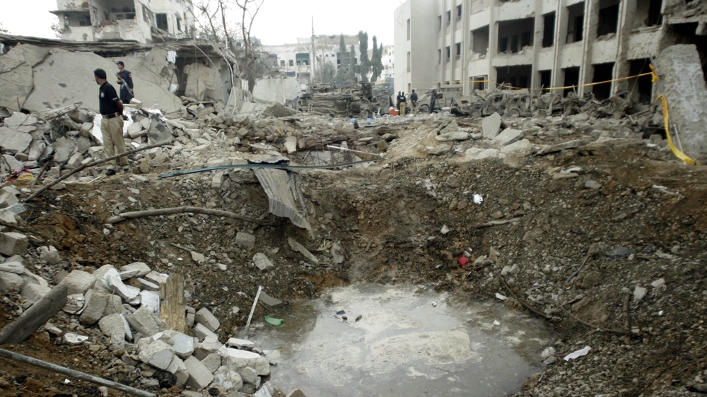 Police survey the crater left by a car bomb detonated before the Criminal Investigation Department HQ in Karachi, Pakistan on November 12, 2010 [Mohammed Athar Khan/The Express Tribune] 