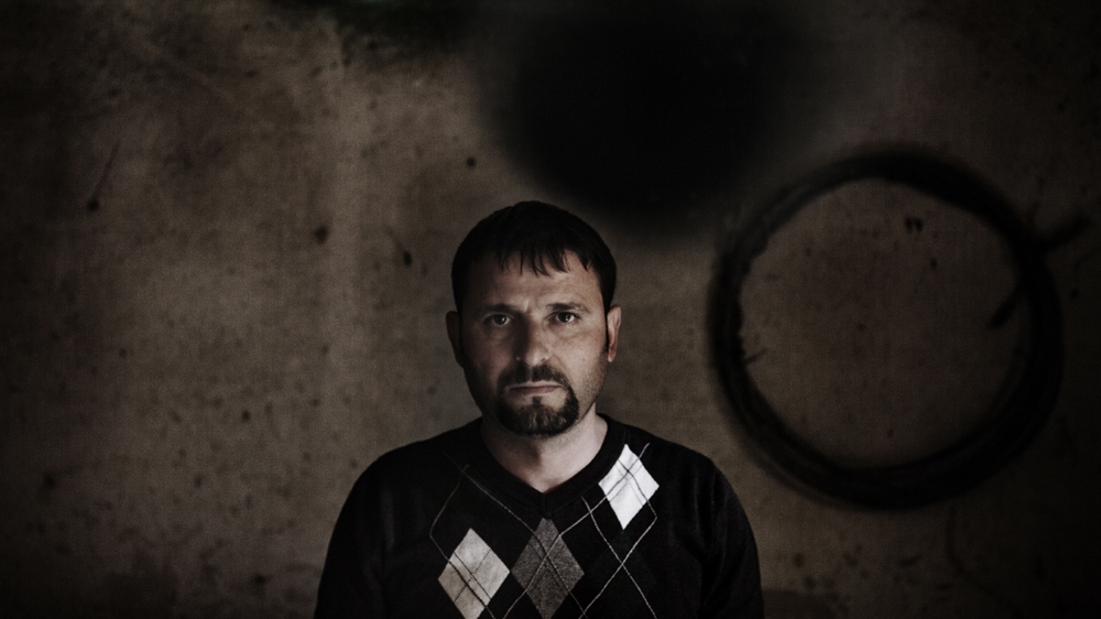 Gjion Mhili’s brother shot and killed a neighbour in a dispute over land. Ever since, Gjion has been unable to leave his home for fear of being targeted in a retaliation killing. His three children - aged 15, 12 and seven - must also stay inside [Carlo Gianferro/Al Jazeera] 