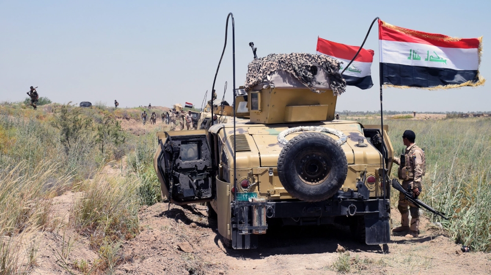 Iraqi military trucks take up position during a military operation southwest of Fallujah city [EPA]