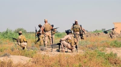 Iraqi soldiers take up a position during a military operation southwest of Fallujah, western Iraq [EPA]